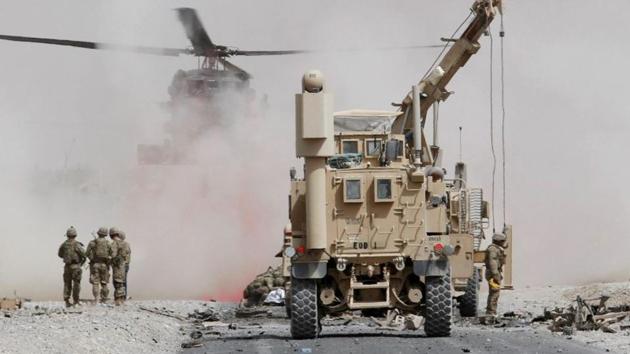 FILE PHOTO: U.S. troops assess the damage to an armoured vehicle of NATO-led military coalition after a suicide attack in Kandahar province, Afghanistan August 2, 2017. (Reuters) FILE PHOTO: U.S. troops assess the damage to an armoured vehicle of NATO-led military coalition after a suicide attack in Kandahar province, Afghanistan August 2, 2017. (Reuters)