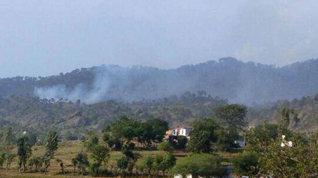 Smoke billows out from the hills after shelling from Pakistan side at Nowshera sector of Rajouri district.(PTI File Photo)