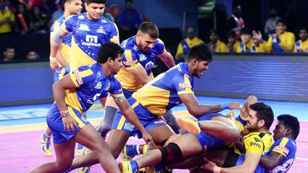Telugu Titans (orange) and Tamil Thalaivas (Blue) players in action during their Pro Kabaddi League match in Mumbai on Thursday. (PTI) Telugu Titans (orange) and Tamil Thalaivas (Blue) players in action during their Pro Kabaddi League match in Mumbai on Thursday. (PTI)