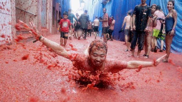 La Tomatina, is a Spanish festival held in the Valencian town of Buñol, in the East of Spain. In this particular festival participants come from all over the world to get involved in harmless fight where more than one hundred metric tons of over ripe tomatoes are thrown in the street. (REUTERS)