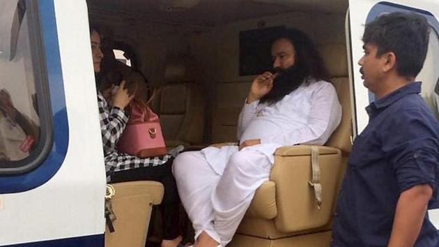 Dera Sacha Sauda chief Gurmeet Ram Rahim in a helicopter in which he was flown from Panchkula to Rohtak town on Friday. (PTI File) Dera Sacha Sauda chief Gurmeet Ram Rahim in a helicopter in which he was flown from Panchkula to Rohtak town on Friday. (PTI File)