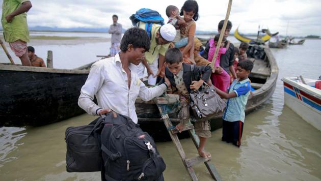 Members of Myanmar's Muslim Rohingya minority get down from a boat after crossing a canal at Shah Porir Deep, in Teknak, Bangladesh, Thursday, Aug. 31, 2017. (AP Photo) Members of Myanmar's Muslim Rohingya minority get down from a boat after crossing a canal at Shah Porir Deep, in Teknak, Bangladesh, Thursday, Aug. 31, 2017. (AP Photo)