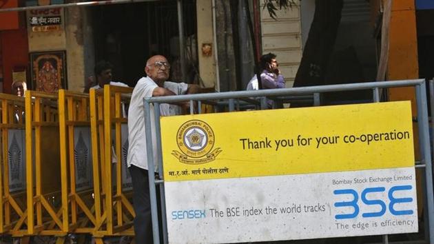 A man looks at a screen across the road displaying the Sensex on the facade of the Bombay Stock Exchange (BSE) building in Mumbai. (Reuters File Photo) A man looks at a screen across the road displaying the Sensex on the facade of the Bombay Stock Exchange (BSE) building in Mumbai. (Reuters File Photo)