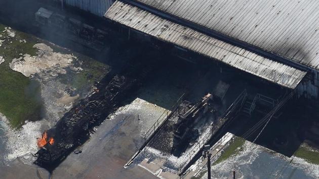 The blasts at the Arkema Inc. plant northeast of Houston ignited a 30- to 40 foot flame and sent up a plume of acrid black smoke .The blaze burned out around midday, but emergency crews held back because of the danger that eight other trailers containing the same compound could blow. However, no serious injuries were reported.   (Adrees Latif / REUTERS) 