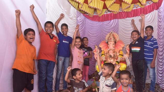 Children of Shree Ganesh Mitra mandal, Sutarwada shout Ganpati Bappa Morya near their Ganesh idol in Pune on Friday.(Pratham Gokhale/HT PHOTO)