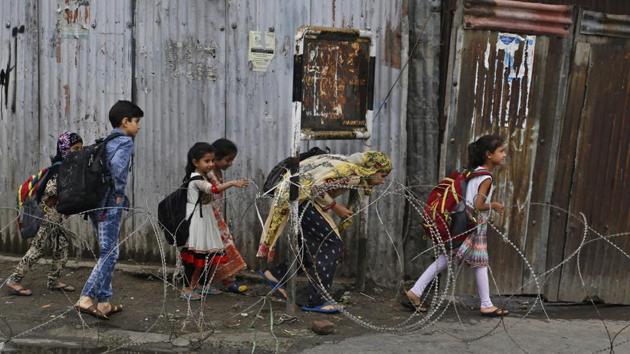 Children cross a temporary check point during curfew in Srinagar. (AP Photo) Children cross a temporary check point during curfew in Srinagar. (AP Photo)