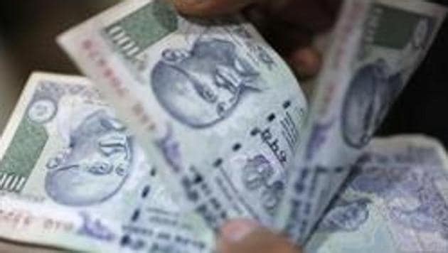 A file photo of an employee counting 100-rupee notes inside a private money exchange office in New Delhi. (REUTERS) A file photo of an employee counting 100-rupee notes inside a private money exchange office in New Delhi. (REUTERS)