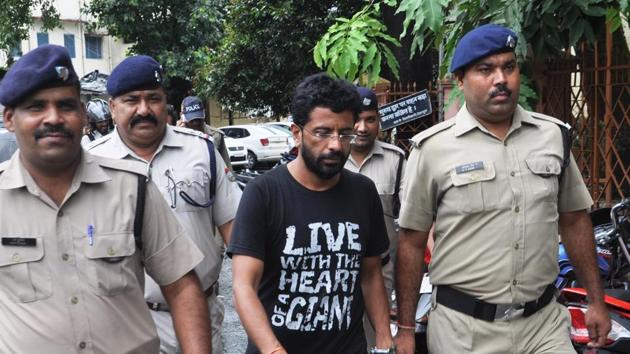 Rajesh Gulati being brought on Friday to a court in Dehradun where he was given a life sentence for the murder of his wife.(Vinay S Kumar/HT photo)