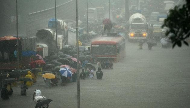 People wade along a flooded street during heavy rain showers in Mumbai on August 29, 2017. Heavy rain brought India's financial capital Mumbai to a virtual standstill on August 29, flooding streets, causing transport chaos and prompting warnings to stay indoors. Dozens of flights and local train services were cancelled as rains lashed the coastal city of nearly 20 million people. (AFP) People wade along a flooded street during heavy rain showers in Mumbai on August 29, 2017. Heavy rain brought India's financial capital Mumbai to a virtual standstill on August 29, flooding streets, causing transport chaos and prompting warnings to stay indoors. Dozens of flights and local train services were cancelled as rains lashed the coastal city of nearly 20 million people. (AFP)