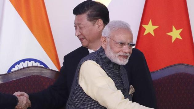 Prime Minister Narendra Modi, left, talks with Chinese President Xi Jinping shake hands with leaders at the BRICS summit in Goa, India.(AP File Photo)