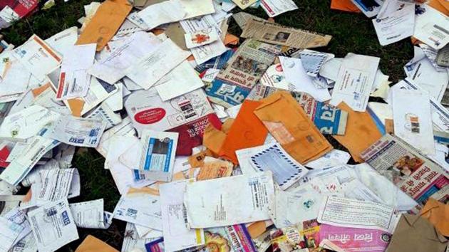 Undelivered letters and marriage invitations were dumped at a forest in Alwar district.(HT Photo)