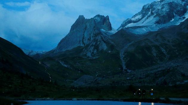 Athletes compete during the 15th Ultra-Trail du Mont-Blanc (UTMB) race near the Combal Lake near Courmayeur, Italy . (Denis Balibouse / REUTERS) Athletes compete during the 15th Ultra-Trail du Mont-Blanc (UTMB) race near the Combal Lake near Courmayeur, Italy . (Denis Balibouse / REUTERS)