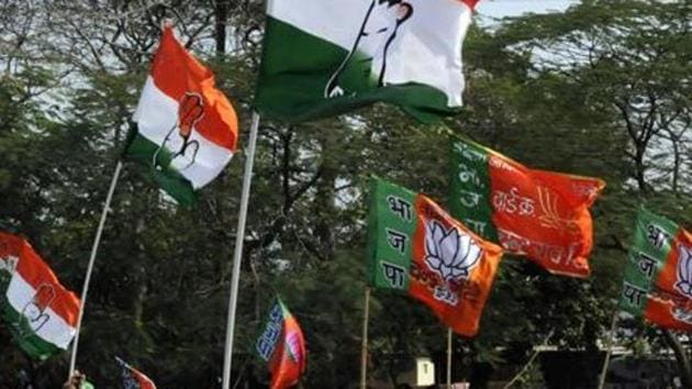 Congress and BJP supporters wave flags in a show of strength in Indore.(HT File Photo)