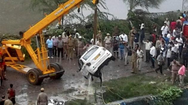 Rescue and relief operations underway after a part of the Ghazipur garbage landfill collapsed in east Delhi on Friday afternoon. Several people and a vehicle were swept into the canal after the mishap.(PTI Photo)