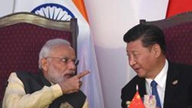Prime Minister Narendra Modi gestures while talking with China's President Xi Jinping during the BRICS leaders' meeting with the BRICS Business Council in Goa on October 16, 2016.(AFP File)