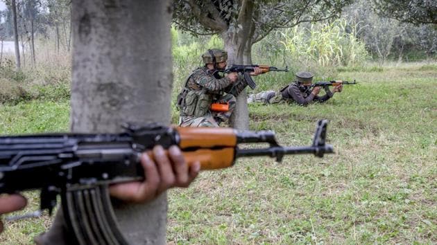 Indian army soldiers take position inside an apple orchard near the site of gunbattle in Pulwama on August 26.(AP Photo)