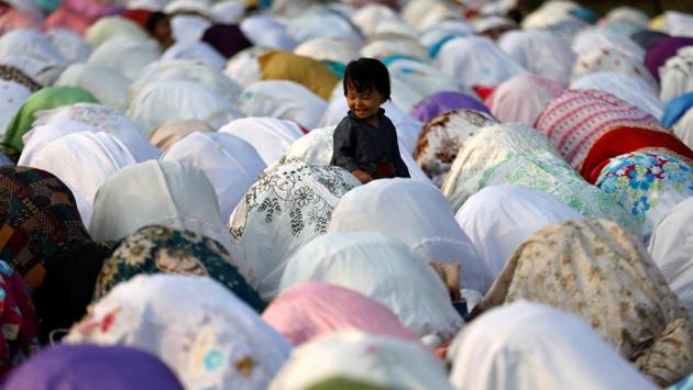 People attend prayers for the Muslim holiday of Eid al-Adha on a street outside of a mosque in Jakarta , Indonesia. (/Darren Whiteside / REUTERS) People attend prayers for the Muslim holiday of Eid al-Adha on a street outside of a mosque in Jakarta , Indonesia. (/Darren Whiteside / REUTERS)