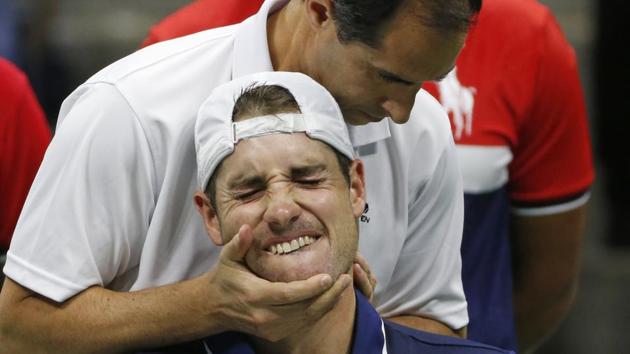 John Isner, of the United States, receives treatment during a medical timeout during a match against Mischa Zverev of Germany. (AP) John Isner, of the United States, receives treatment during a medical timeout during a match against Mischa Zverev of Germany. (AP)