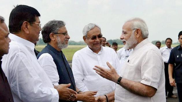 Prime Minister Narendra Modi with Bihar chief minister Nitish Kumar and deputy chief minister Sushil Kumar Modi at Paurnea Airport .(PTI File Photo)
