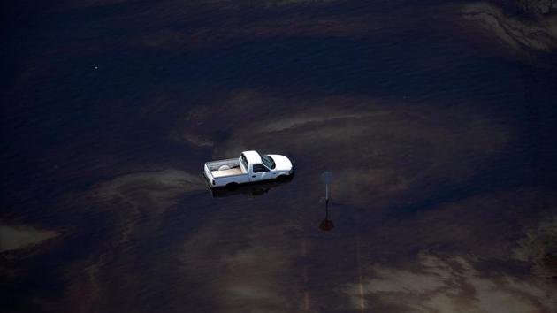 A vehicle sits amid leaked fuel mixed in with flood waters caused by Tropical Storm Harvey in the parking lot of Motiva Enterprises LLC in Port Arthur, Texas, U.S. (Adrees Latif / REUTERS) A vehicle sits amid leaked fuel mixed in with flood waters caused by Tropical Storm Harvey in the parking lot of Motiva Enterprises LLC in Port Arthur, Texas, U.S. (Adrees Latif / REUTERS)