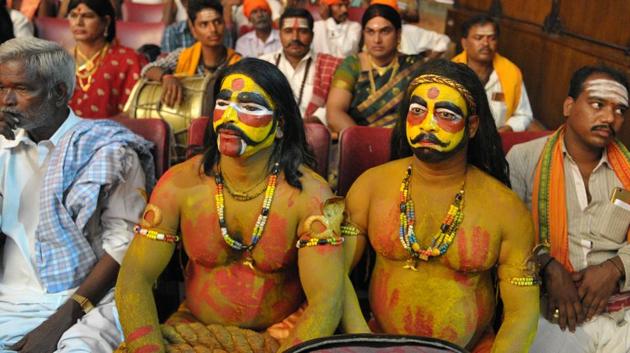 Indian artists Madan Singh Yadav (R) and Raju (L) dressed as Potharaju, brother of the Hindu goddess Maha Kali, wait to perform at the folk arts festival Janapada Jatara in Hyderabad . (NOAH SEELAM / AFP) Indian artists Madan Singh Yadav (R) and Raju (L) dressed as Potharaju, brother of the Hindu goddess Maha Kali, wait to perform at the folk arts festival Janapada Jatara in Hyderabad . (NOAH SEELAM / AFP)