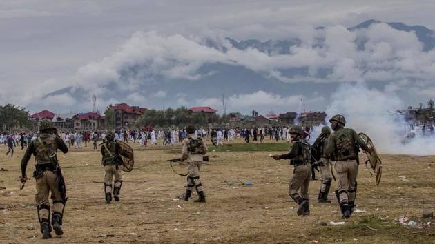 Paramilitary soldiers chase Kashmiri Muslims during a protest outside Eidgha, a prayer ground, in Srinagar. Forces used tear gas and pellet guns to disperse hundreds of stone-throwing protesters who took to the streets after Eid al-Adha prayers. (Dar Yasin / AP) Paramilitary soldiers chase Kashmiri Muslims during a protest outside Eidgha, a prayer ground, in Srinagar. Forces used tear gas and pellet guns to disperse hundreds of stone-throwing protesters who took to the streets after Eid al-Adha prayers. (Dar Yasin / AP)