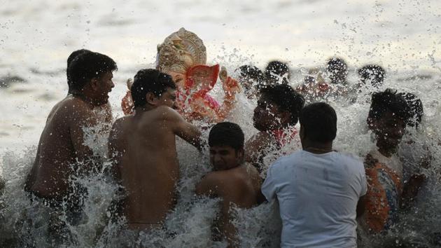 Indian Hindu devotees carry an idol of elephant-headed Hindu deity Ganesha for immersion at Dadar Chowpatty beach on the seventh day of the eleven-day long festival Ganesh Chaturthi in Mumbai. Hindu devotees bring home idols of Lord Ganesha in order to invoke his blessings for wisdom and prosperity. The eleven day Ganesh Festival sees millions of Hindus gathering along the western city's coast to immerse the elephant-god idols in the Arabian sea. (PUNIT PARANJPE / AFP) Indian Hindu devotees carry an idol of elephant-headed Hindu deity Ganesha for immersion at Dadar Chowpatty beach on the seventh day of the eleven-day long festival Ganesh Chaturthi in Mumbai. Hindu devotees bring home idols of Lord Ganesha in order to invoke his blessings for wisdom and prosperity. The eleven day Ganesh Festival sees millions of Hindus gathering along the western city's coast to immerse the elephant-god idols in the Arabian sea. (PUNIT PARANJPE / AFP)