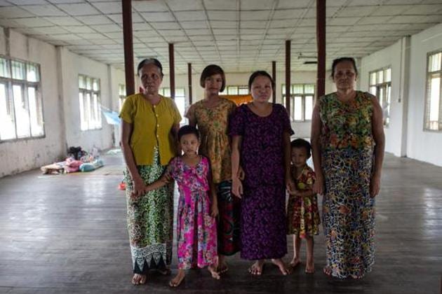In this photograph taken on August 30, 2017, Daw Bu (L), 64, who fled from Maungdaw, is seen with her sister (R), daughter-in-law (C) and three grandchildren at an internally displaced persons (IDP) camp in Sittwe.(AFP Representative Photo) In this photograph taken on August 30, 2017, Daw Bu (L), 64, who fled from Maungdaw, is seen with her sister (R), daughter-in-law (C) and three grandchildren at an internally displaced persons (IDP) camp in Sittwe.(AFP Representative Photo)