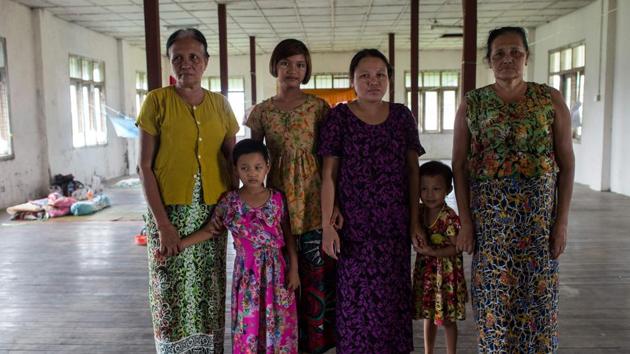 Daw Bu (L), 64, who fled from Maungdaw, is seen with her sister (R), daughter-in-law (C) and three grandchildren at an internally displaced persons (IDP) camp in Sittwe. Rakhine, Myanmar's poorest state, has become a crucible of religious hatred focused on the Muslim Rohingya, who are reviled and perceived as illegal immigrants in Buddhist-majority Myanmar.(AFP Photo)