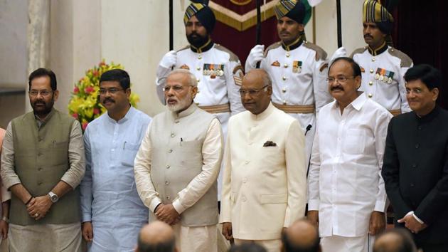 Prime Minister Narendra Modi (3rd left), President Ramnath Kovind (3rd R) and vice-president Venkiah Naidu (2nd R), pose with the newly sworn-in ministers Mukhtar Abbas Naqvi (L), Dharmendra Pradhan (2nd L) and Piyush Goyal (R) in New Delhi on Sunday.(AP)