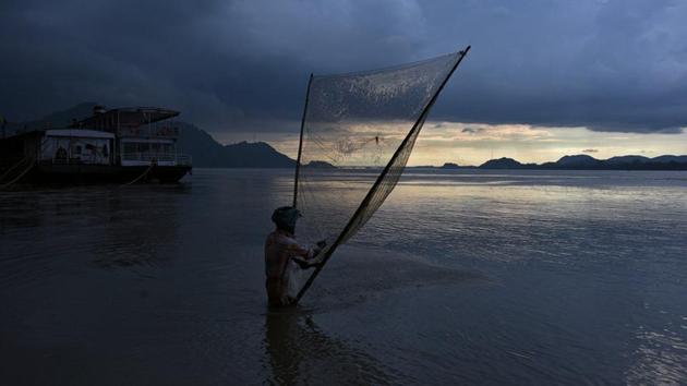 A man catches fish on the banks of the Brahmaputra river in Guwahati. (Anuwar Hazarika / REUTERS) A man catches fish on the banks of the Brahmaputra river in Guwahati. (Anuwar Hazarika / REUTERS)
