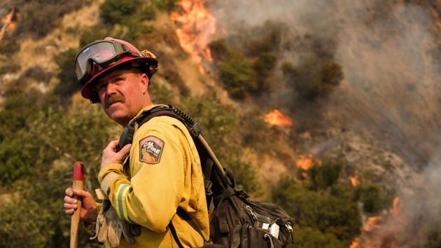 A crew member with the California Department of Forestry and Fire Protection battles a brushfire on the hillside in Burbank. (AP) A crew member with the California Department of Forestry and Fire Protection battles a brushfire on the hillside in Burbank. (AP)