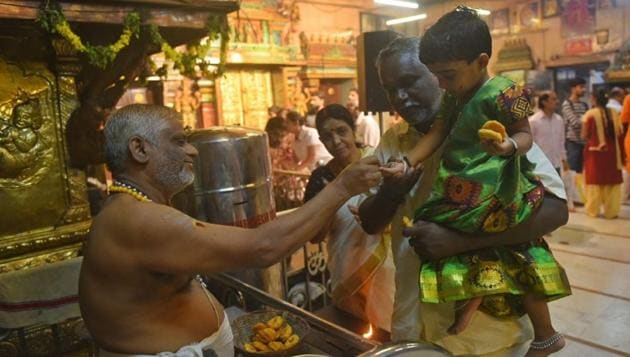 A family at the Asthika Samaj Temple in Matunga. (Pratik Chorge/HT) A family at the Asthika Samaj Temple in Matunga. (Pratik Chorge/HT)