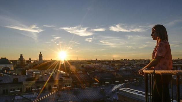 A tourist looks at the city during a visit to the first official tour of the roofs in St. Petersburg. (Olga Maltseva/AFP) A tourist looks at the city during a visit to the first official tour of the roofs in St. Petersburg. (Olga Maltseva/AFP)