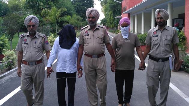 Duni Chand and Ranjit Singh (faced covered) in police custody.(HT Photo)