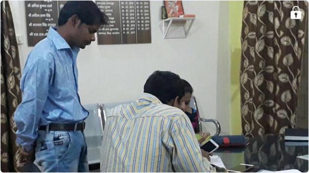 The accused, Durgesh Aggarwal (left) at a police station after his arrest for making obscene calls to 300 policewomen. (HT PHOTO) The accused, Durgesh Aggarwal (left) at a police station after his arrest for making obscene calls to 300 policewomen. (HT PHOTO)