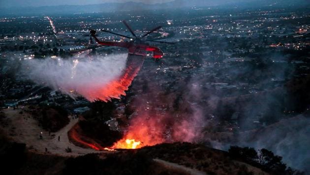 A wildfire on the northern edge of Los Angeles on Saturday fanned into what the mayor called the largest blaze in the city’s history, prompting evacuation of hundreds of people and closure of a major highway. Spread over nearly 5,900 acres and named after the canyon area where it erupted on Friday, La Tuna has led authorities to evacuate more than 700 homes in a north Los Angeles neighbourhood and in nearby Burbank and Glendale. (Kyle Grillot / REUTERS) A wildfire on the northern edge of Los Angeles on Saturday fanned into what the mayor called the largest blaze in the city’s history, prompting evacuation of hundreds of people and closure of a major highway. Spread over nearly 5,900 acres and named after the canyon area where it erupted on Friday, La Tuna has led authorities to evacuate more than 700 homes in a north Los Angeles neighbourhood and in nearby Burbank and Glendale. (Kyle Grillot / REUTERS)