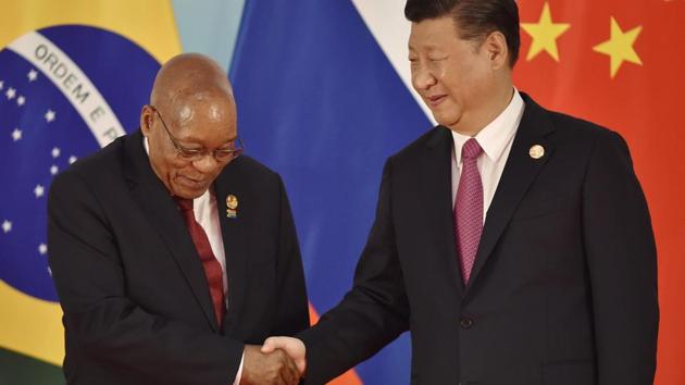 Chinese President Xi Jinping (R) and South Africa's President Jacob Zuma shake hands before the group photo during the BRICS Summit in China. South Africa will present itself as the leading voice of the African world and is expected to raise issues of peace and development for the continent at the summit. (Kenzaburo Fukuhara / AFP)