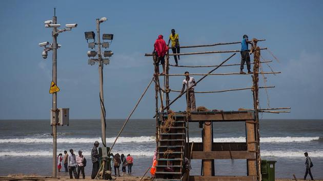 EYE IN THE SKY: BMC worker erect a watchtower at Juhu. (Satish Bate/HT Photo) 