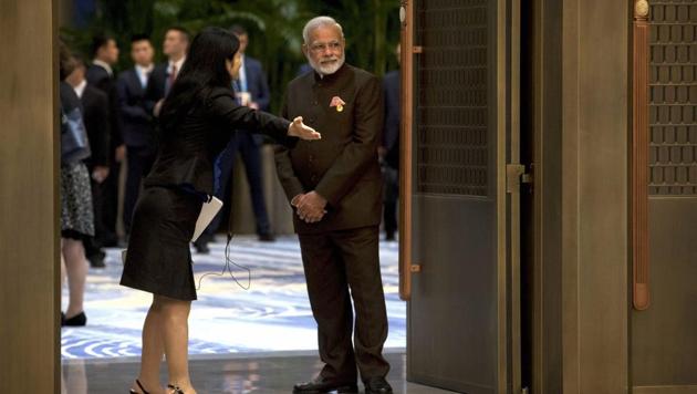 A staff member gestures to Indian Prime Minister Narendra Modi as he waits to enter a reception hall during the BRICS Summit in southeastern China's Fujian province on September 4, 2017. (AP) A staff member gestures to Indian Prime Minister Narendra Modi as he waits to enter a reception hall during the BRICS Summit in southeastern China's Fujian province on September 4, 2017. (AP)