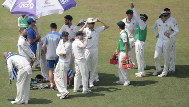 Australian players take shelter under umbrellas during the drinks break on the first day of their second test cricket match against Bangladesh in Chittagong, Bangladesh, Monday, Sept. 4, 2017. (AP Photo/A.M. Ahad) (AP) Australian players take shelter under umbrellas during the drinks break on the first day of their second test cricket match against Bangladesh in Chittagong, Bangladesh, Monday, Sept. 4, 2017. (AP Photo/A.M. Ahad) (AP)
