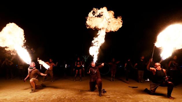 Burning Man participants from the Northern Fire Dynamic fire conclave out of Minnesota, Wisconsin and Iowa breath fire simultaneously during their fire dance performance in front of the effigy of ‘The Man’. (Jim Bourg / REUTERS) 
