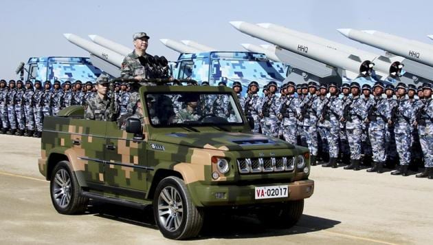 Chinese President Xi Jinping stands on a military jeep as he inspects troops of the People's Liberation Army during a military parade in July 2017(Xinhua via AP)