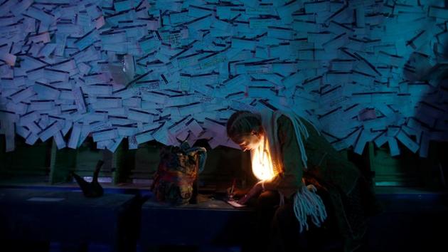 A participant fills out emotional baggage tickets at Big Imagination's 747 installation, a gutted Boeing 747 airliner which served as a performance venue, an incubator for art and discussions at the festival venue. (Jim Urquhart / REUTERS) 