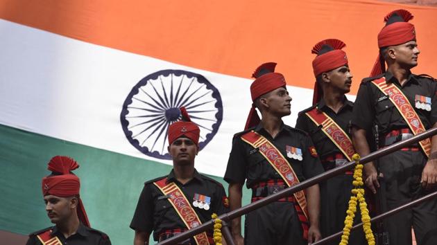 Army personnel pose in front of the national flag during the Independence Day celebrations. Former chiefs of the army will be briefed about the Doklam standoff at a special conclave.(Raj K Raj/HT PHOTO)