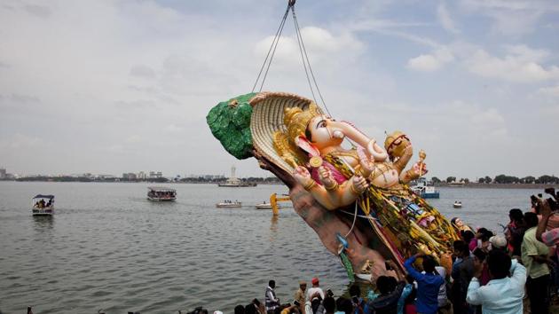 In Hyderabad, a giant idol of the elephant-headed Hindu god Ganesha is immersed in Hussain Sagar Lake on the final day of Ganesh Chaturthi. (AP/Mahesh Kumar ) In Hyderabad, a giant idol of the elephant-headed Hindu god Ganesha is immersed in Hussain Sagar Lake on the final day of Ganesh Chaturthi. (AP/Mahesh Kumar )