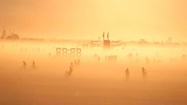 The sun sets over Black Rock City, also known as ‘the playa’ on September 1, 2017. The festival space is littered with art installations, shrines and special retreats that represent the diversity of their origins and promote inclusiveness among festival goers. (Jim Urquhart / REUTERS) 