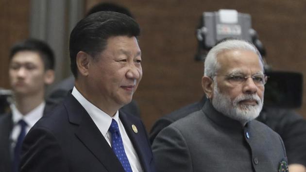 Chinese President Xi Jinping, left, and Indian Prime Minister Narendra Modi arrive for the Dialogue of Emerging Market and Developing Countries on the sideline of the BRICS Summit in Xiamen, China.(AP Photo)