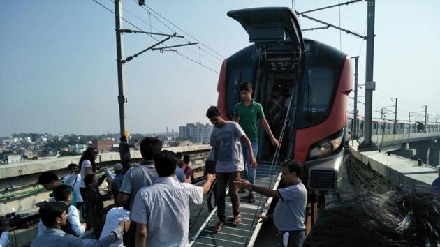 Passengers being taken out of the emergency exit after a Lucknow Metro train developed a snag on Wednesday. (HT photo) Passengers being taken out of the emergency exit after a Lucknow Metro train developed a snag on Wednesday. (HT photo)