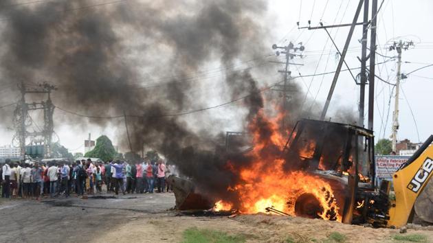 The mob burnt at least heavy machinery equipment used during an anti-encroachment drive in Patna on Tuesday.(Santosh Kumar/HT photo)